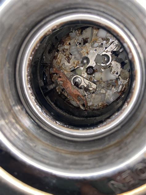 Moen garbage disposal jam, how do I get this metal piece out